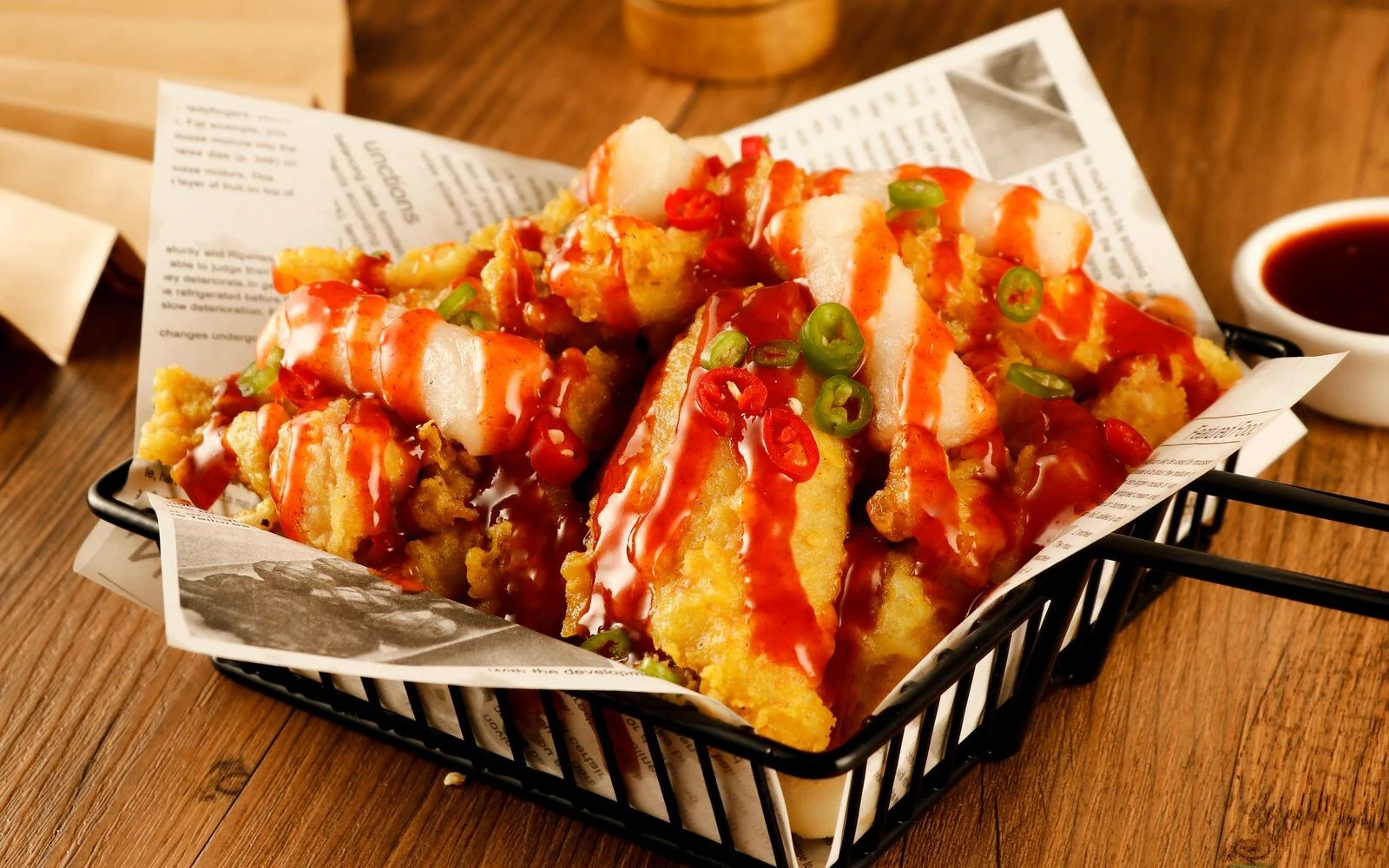 Crispy shredded chicken in a chilli sauce garnished with red and green chillies