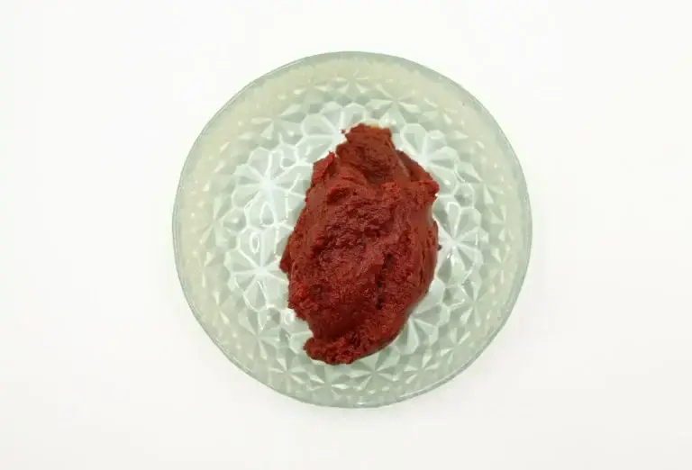 Red chilli paste in a glass bowl seen from above