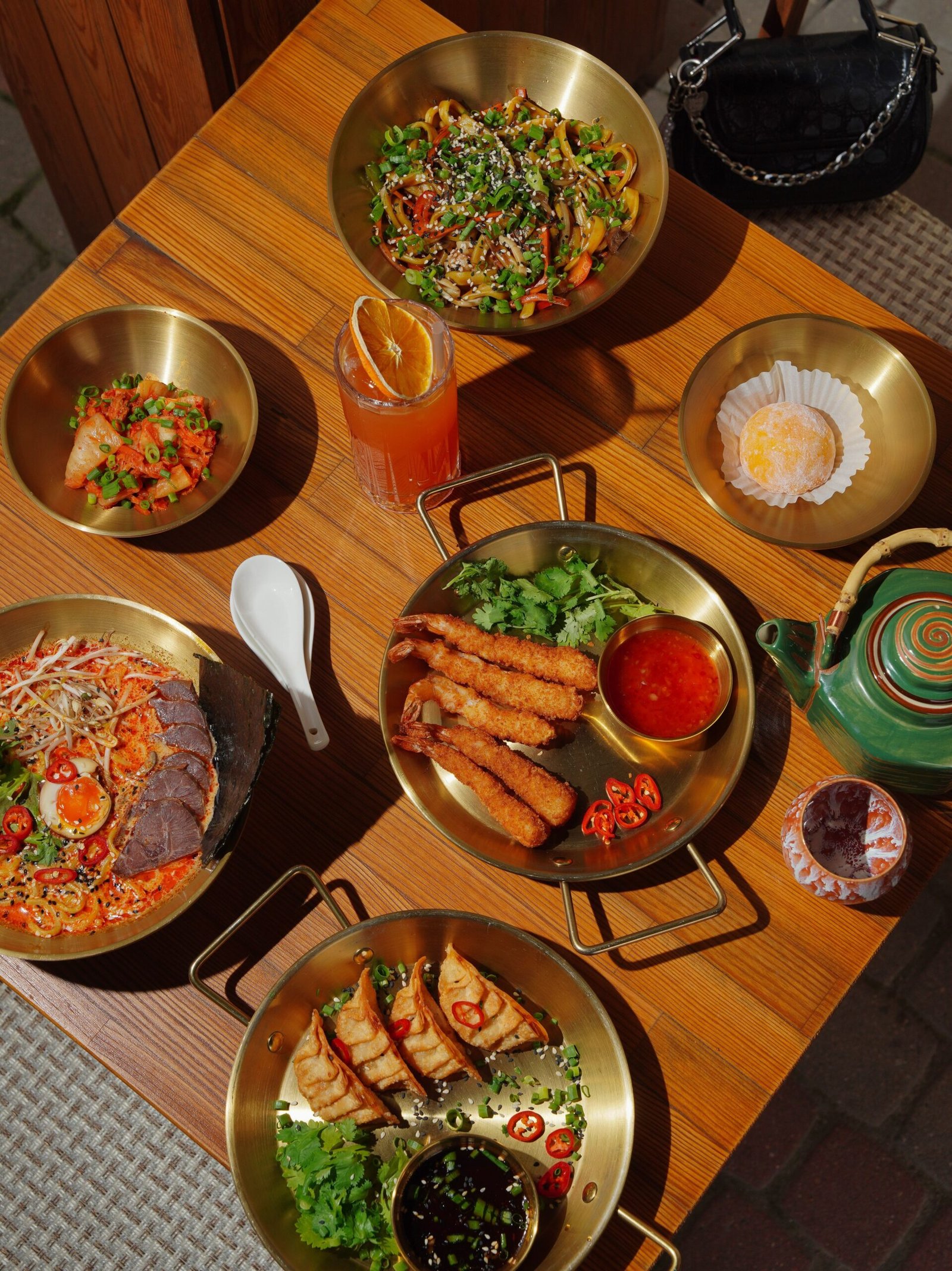 A spread of Asian dishes on a wooden table